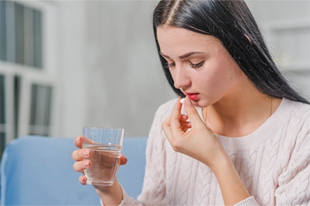 B-Complex & B12 IV Drip for Metabolism in Chennai Woman preparing to take B12 supplement to boost energy, metabolism, and regulate mood naturally